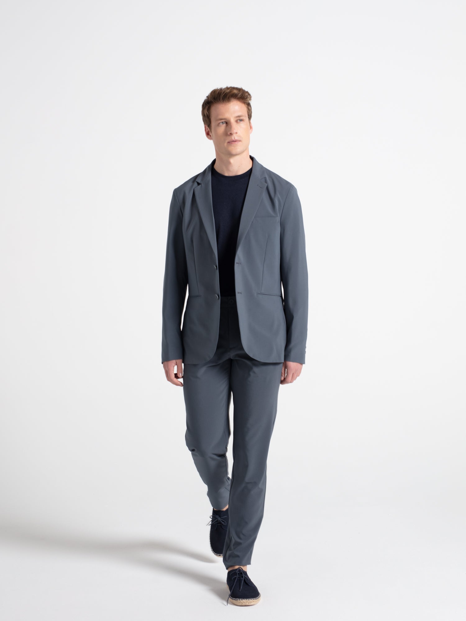 Technical fabric trousers with a checkered pattern and pleats.